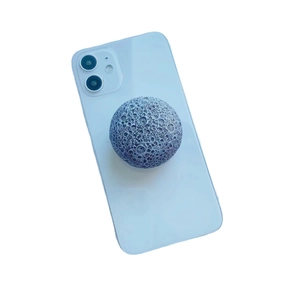 3D moon textured phone grip holder with crater details on blue smartphone back