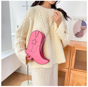 Detail of creative pink boot-shaped bag with star patterns and metal chain strap