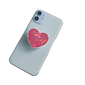 Pink heart-shaped griptok with sparkling crystal texture on a blue smartphone