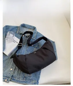 Gros plan détaillé d'un sac à bandoulière rembourré noir avec une texture plissée chic