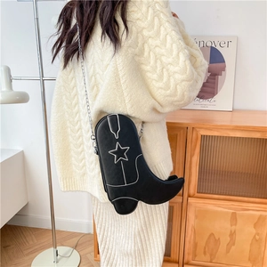 Creative boot-shaped crossbody bag in black leather with white star stitching and silver chain