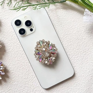 Macro detail of luxury flower phone grip with crystals and iridescent gemstones