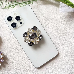 Macro detail of luxury diamond phone socket with gray rhinestones and gold base