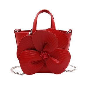 Chic red petal-shaped bucket bag with floral accents and silver chain strap