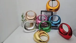 Detail of colorful hollow acrylic handbags with metallic plating finish in various vibrant colors