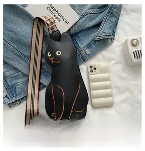 Detail of creative black cat crossbody bag with colorful embroidery and woven strap