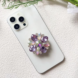 Detailed view of luxury flower popsocket with purple rhinestones and crystal petals