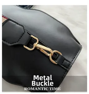 Detail of high-quality golden metal hardware clip on a black leather crossbody bag