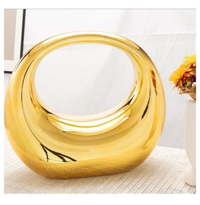Macro detail of glossy golden acrylic clutch with reflective metallic finish surface