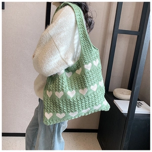 Detailed knit texture of green heart tote bag showing quality craftsmanship and style