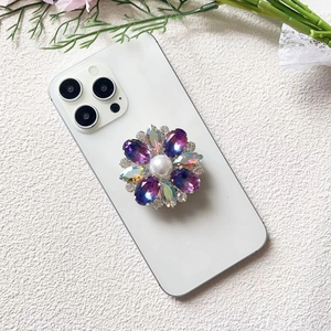 Close-up of luxury flower phone grip with purple rhinestones and large white pearl