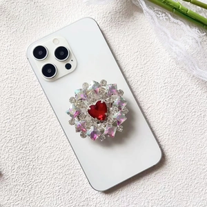 Close-up of luxury red heart diamond phone grip with sparkling crystal rhinestones