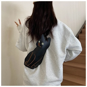 Detail showing the back view of a cute black cat-shaped crossbody bag with soft leather