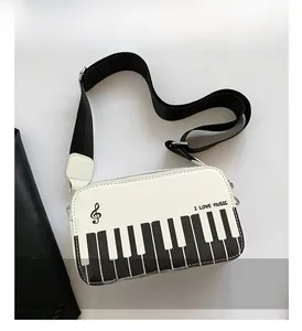 Detail of the piano keyboard pattern and musical notes on the stylish white crossbody bag