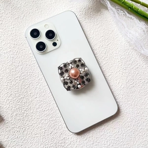 Close-up of luxury flower phone grip with pink pearl and dark grey rhinestones