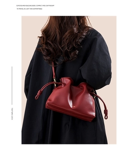 Vue détaillée du sac nuage plissé bordeaux montrant la texture cuir et le logo doré