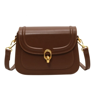 Minimalist brown leather crossbody bag with elegant gold metal buckle and adjustable strap