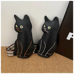 Close-up of cat-shaped crossbody bags featuring detailed embroidery and striped straps