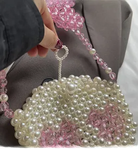 Detail of the handmade pearl and pink crystal beaded bag with functional loop closure