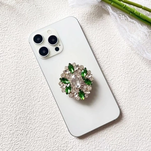 Detailed macro of a green floral rhinestone phone socket with sparkling crystals