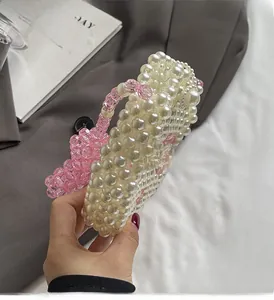Detailed handmade heart-shaped pearl bead handbag with pink and white woven accents