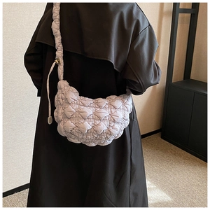 Detail of light purple quilted cloud bag with puffy texture and scrunchie shoulder strap