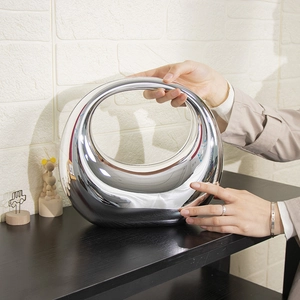 Chic silver acrylic handbag with mirror finish and stylish circular ring design