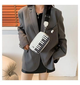 Detail of the piano keyboard design and I LOVE MUSIC embroidery on the crossbody bag