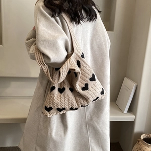 Knitted heart tote bag in beige with black patterns and woven texture for winter
