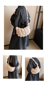 Detailed close-up of a creamy white quilted dumpling bag with bubble pleated shoulder strap