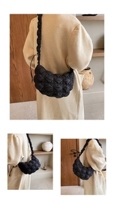 Detail of black quilted cloud underarm bag showing ruffled strap and soft texture