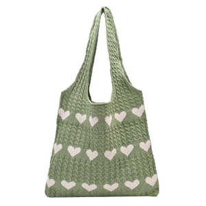 Chic green knitted tote bag with pink heart pattern and chunky cable knit texture