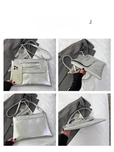 Metallic silver envelope clutch bag shown with a smartphone to display product size