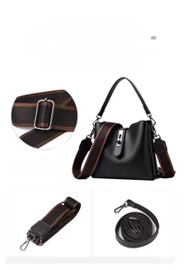 Detail of black pebbled leather bucket bag featuring silver hardware and dual strap options
