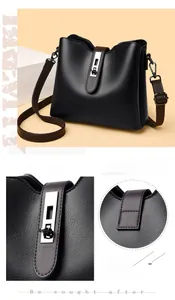 Detail of silver rectangular metal lock and black litchi pattern leather on the handbag