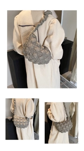 Detail of quilted puffer hobo bag showing puffy texture and pleated shoulder strap