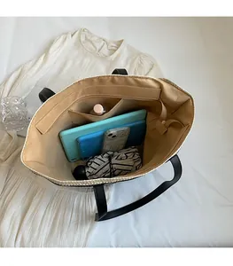 Top view of spacious straw tote bag interior showing capacity for tablet and essentials