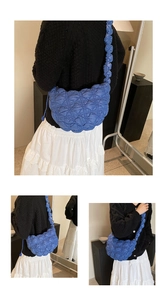Detail of blue quilted cloud bag featuring a ruched strap and soft puffed texture