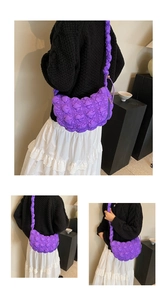 Detail of purple quilted cloud bag with padded square texture and ruched shoulder strap