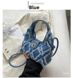 Detail of blue denim crescent bag with white quilted fringe and silver twist lock
