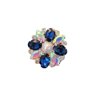 Luxury flower-shaped collapsible phone grip with blue crystals and pearl accents