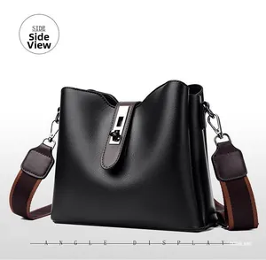Side view of black faux leather bucket bag featuring a silver twist lock and wide strap