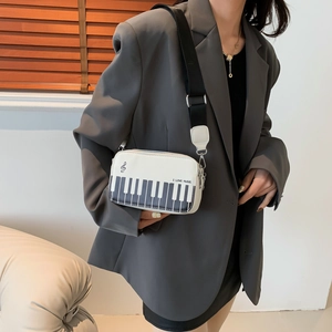 Fashionable white piano keyboard crossbody bag with musical note embroidery and wide strap