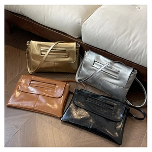 Detail view of stylish clutch bags in gold silver brown and black with pleated texture