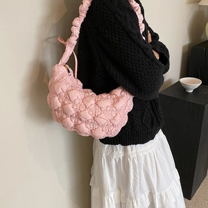 Pink quilted puffer underarm bag with a puffy cloud texture and ruched shoulder strap