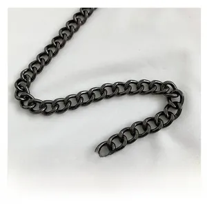 Detail of a dark gray metal chain strap with thick polished rings for crossbody bags