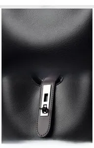 Detailed view of black litchi grain texture and silver metal twist lock on a bucket bag