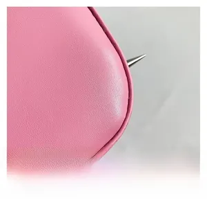 Macro shot of pink leather texture with silver cone studs and fine stitching details