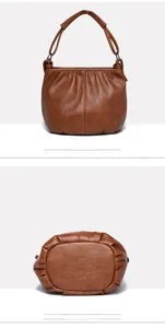 Detailed views showing brown pleated leather texture and bottom base of a retro handbag