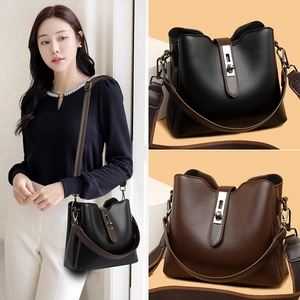 Women soft leather bucket bag with adjustable woven strap and metal buckle detail